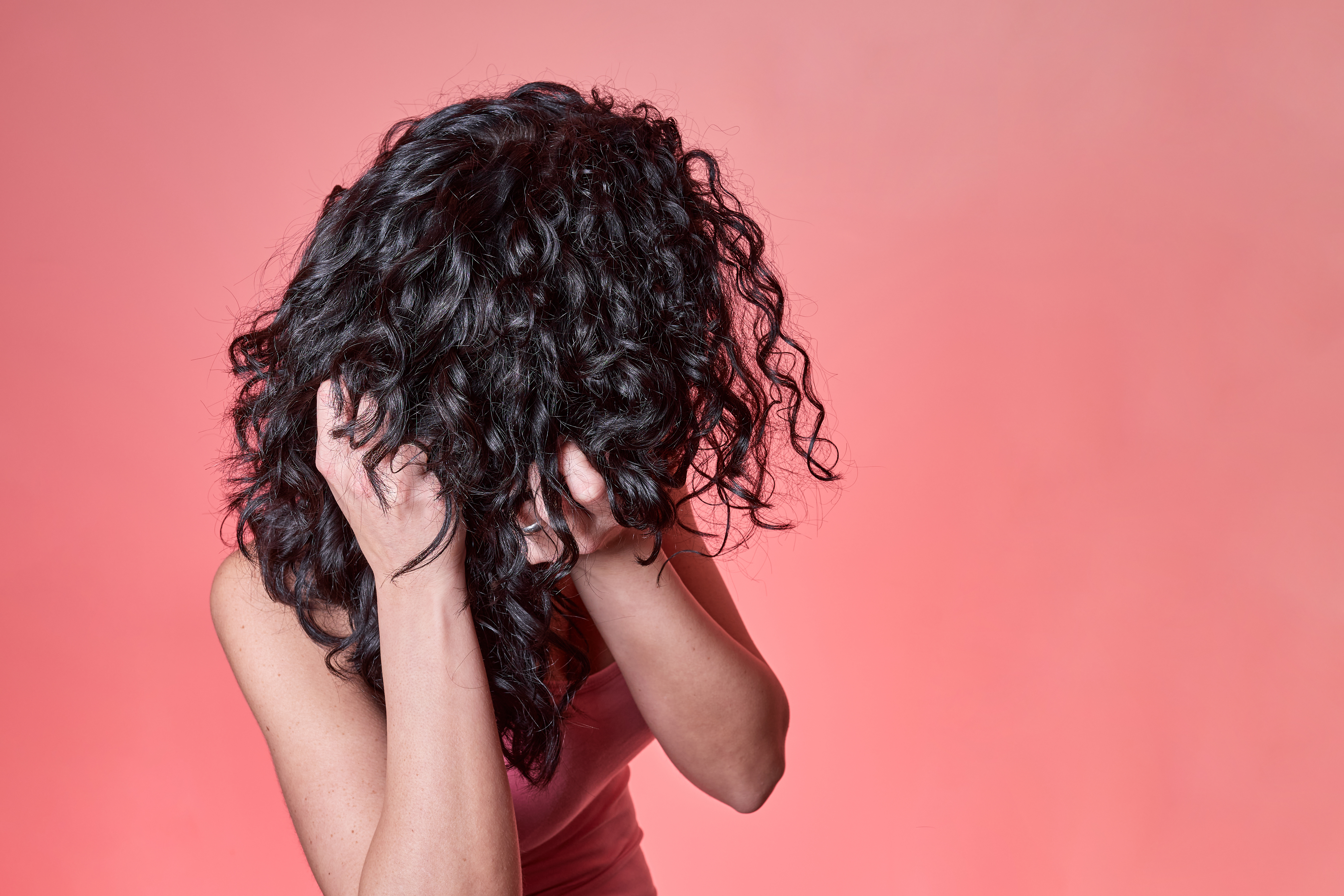 Woman touching her curly hair