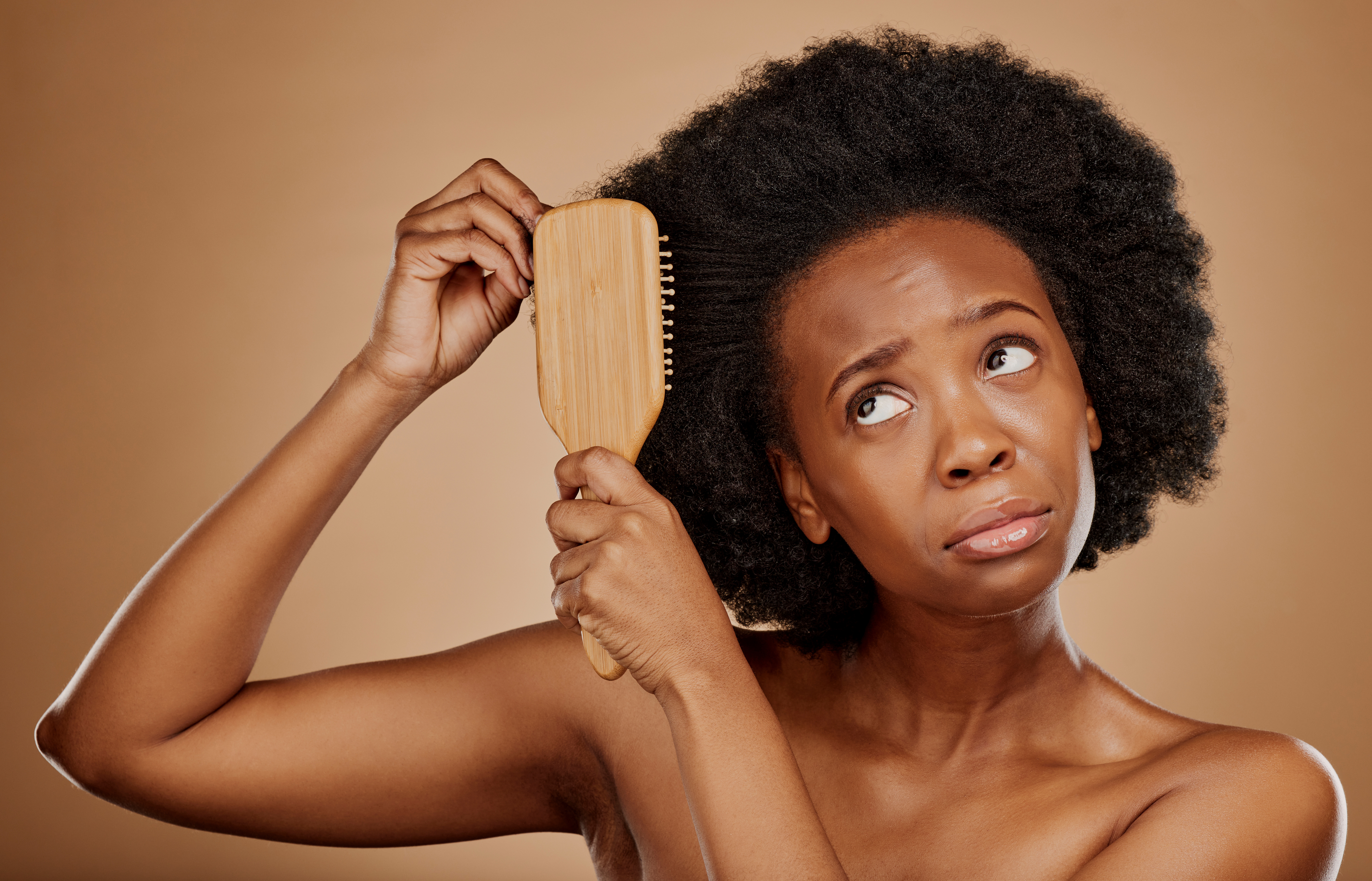Woman with curly hair struggles